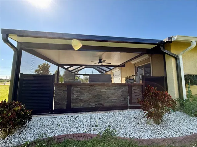 Gate featuring a sunroom and a ceiling fan
