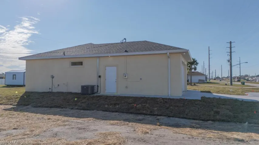 Back of house featuring central AC unit