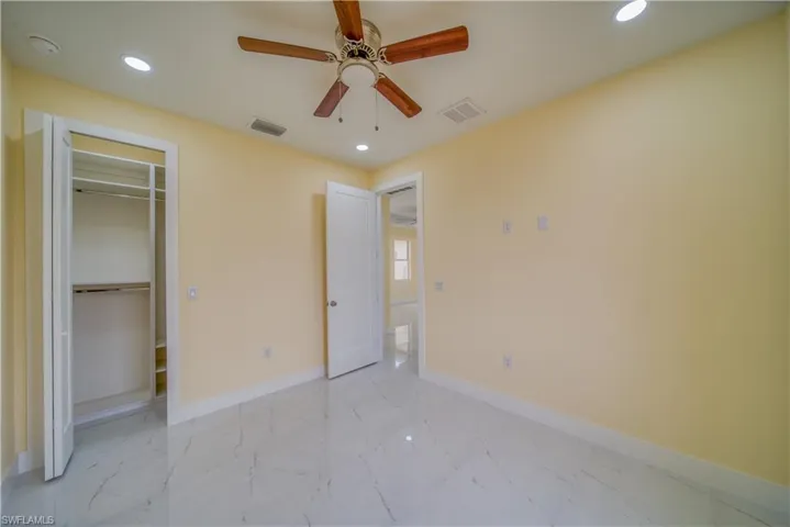 Unfurnished bedroom with a closet and ceiling fan
