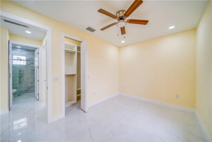 Unfurnished bedroom featuring ceiling fan and a closet