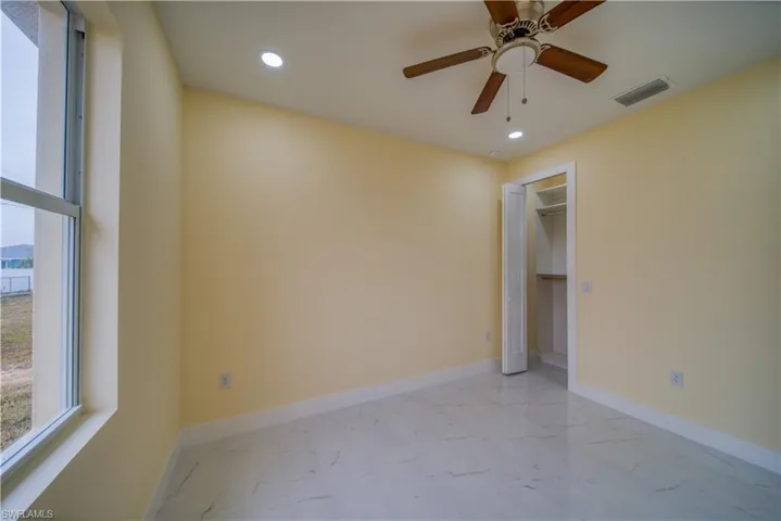 Unfurnished bedroom with a closet and ceiling fan
