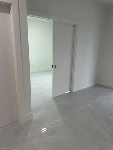Spare room featuring light tile floors