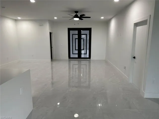 Tiled spare room with ceiling fan