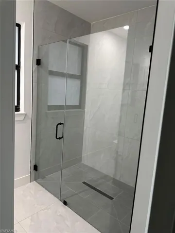 Bathroom featuring tile flooring and an enclosed shower