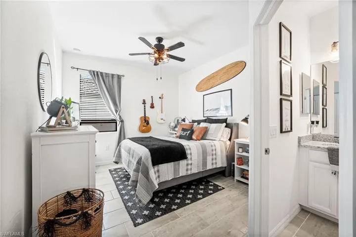 Bedroom with a ceiling fan and baseboards