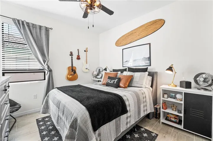 Bedroom featuring ceiling fan and baseboards