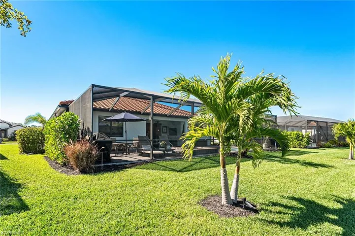 View of yard with a patio and glass enclosure