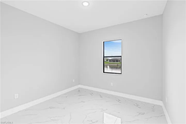 Spare room featuring light marble finish flooring and recessed lighting