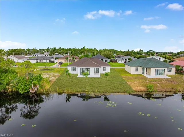 Aerial perspective of suburban area with a nearby body of water