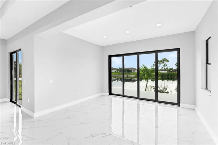 Empty room with light marble finish flooring, plenty of natural light, and recessed lighting