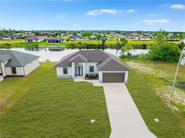 Aerial perspective of suburban area featuring a nearby body of water