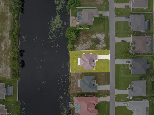 Aerial view of property's location with nearby suburban area