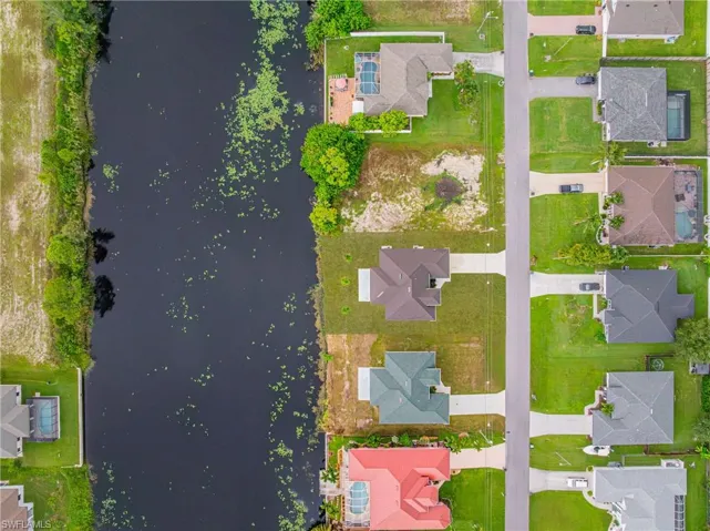 Aerial view of residential area featuring a large body of water