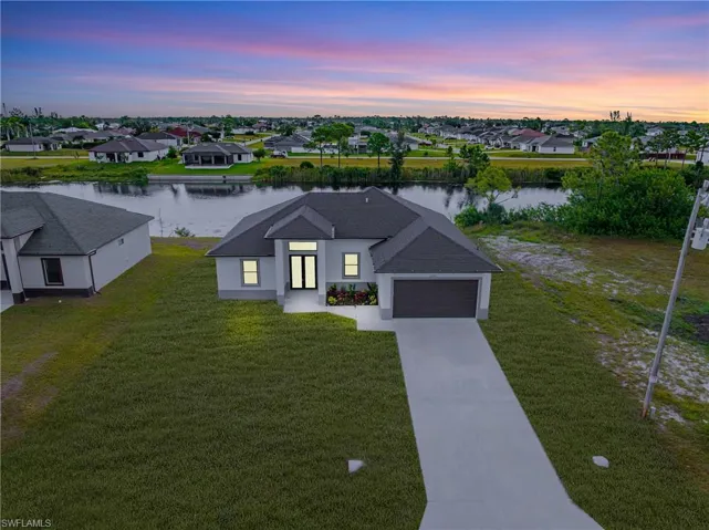 Aerial view at dusk of a water view and a residential view