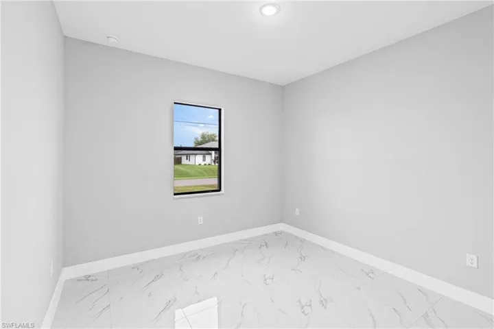 Unfurnished room with light marble finish flooring and recessed lighting