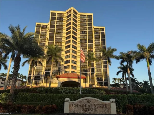 High-rise building featuring multiple stories of residential units and a prominent entrance