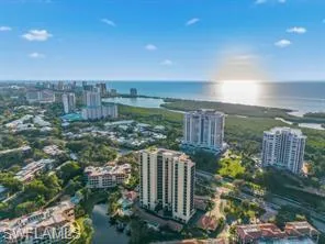 Aerial perspective showcasing coastal residences, high-rise buildings, and extensive waterways