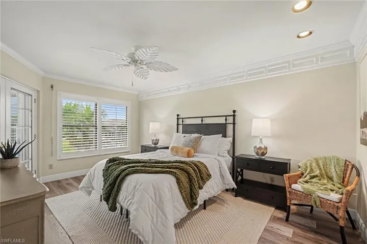 Recessed lighting, crown molding, wood-finish flooring, plantation shutters, and French doors