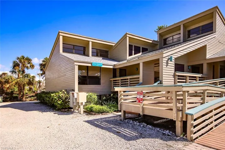 Front view of property with roof with shingles and a deck