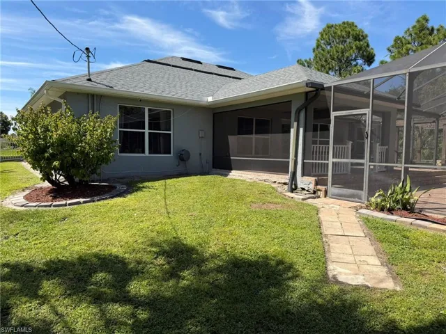 Screened outdoor living area with a paver patio and a partially covered lanai