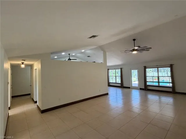 Vaulted ceiling with recessed lighting and ceiling fans