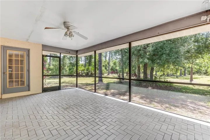 Screened in patio with multiple entrances into the home. Single framed door pictured here and a set of French doors not pictured.