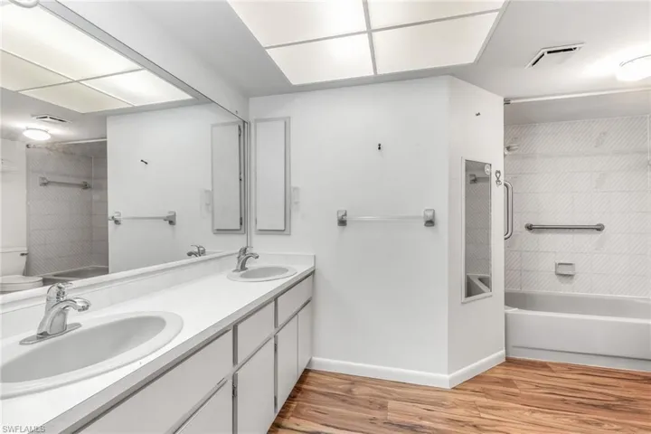 Master bathroom featuring dual bowl vanity and shower / bath combo.
