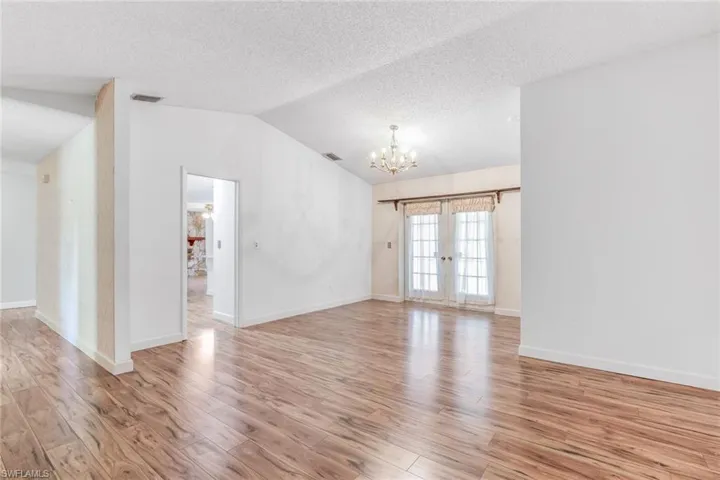View of French doors leading you to screened in patio and entry way into the kitchen.