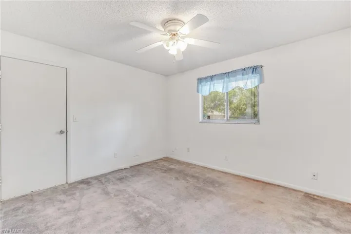 Spare room with door leading into the garage.