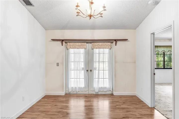French doors leading from formal dining room to screened in patio