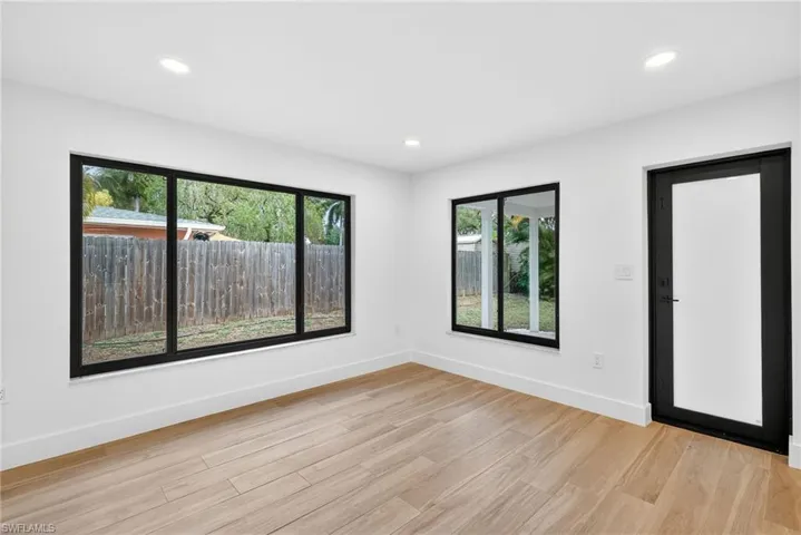 Empty room featuring light wood-style floors and recessed lighting