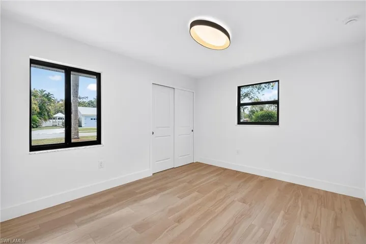Unfurnished bedroom featuring light wood-style flooring and a closet