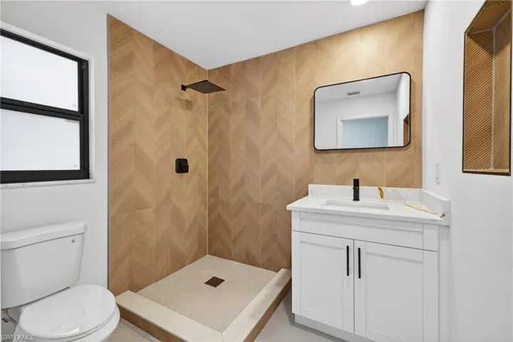 Bathroom with vanity and a tile shower