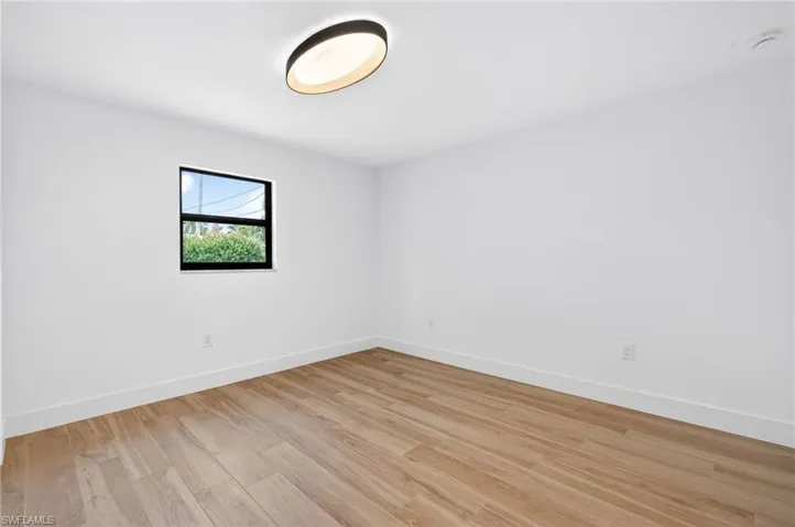 Spare room with light wood finished floors and baseboards