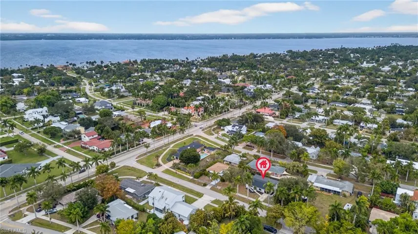 Aerial view of property's location featuring nearby suburban area and a large body of water
