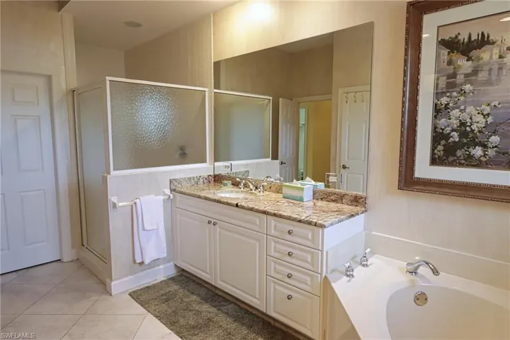 Full bathroom with a garden tub, tile patterned flooring, vanity, and a shower stall