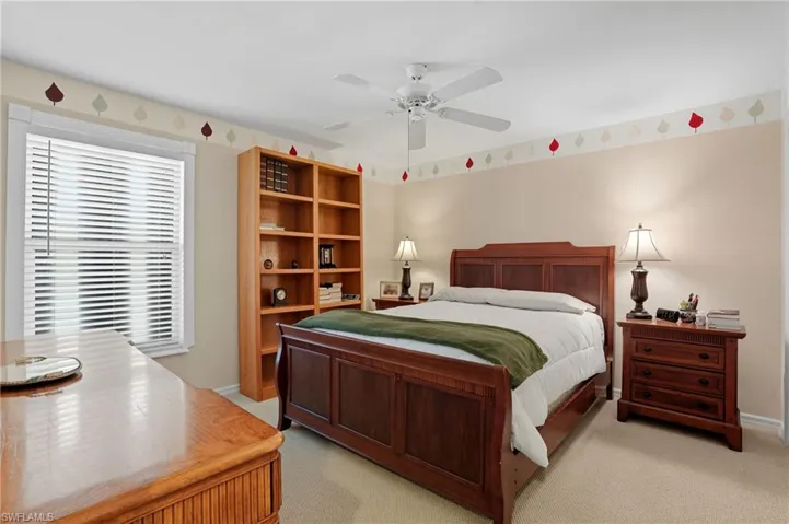 Bedroom with light colored carpet and ceiling fan