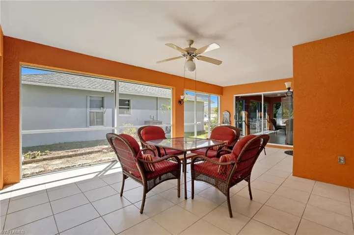 Sunroom / solarium with tile patterned flooring and a textured wall