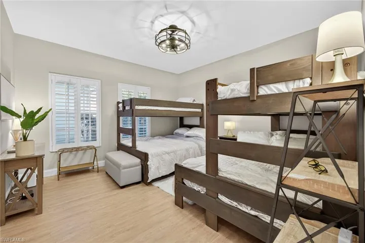 Bedroom with light wood-style floors and baseboards
