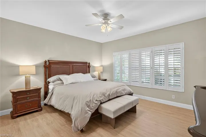 Bedroom with light wood-style flooring and a ceiling fan