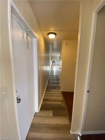 Hallway with dark wood-style flooring