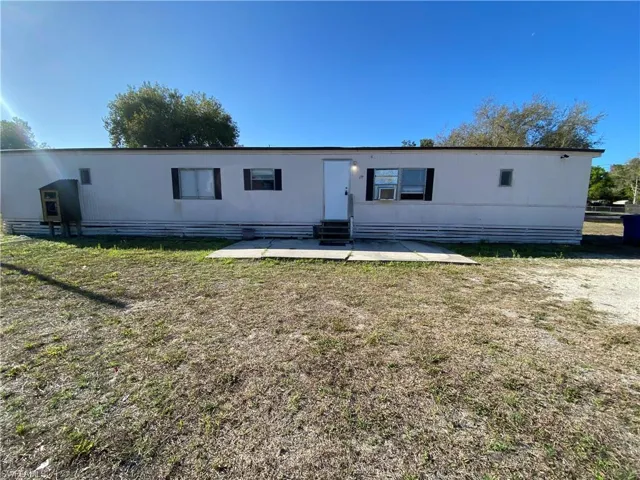 Back of property with a patio area, entry steps, and a yard
