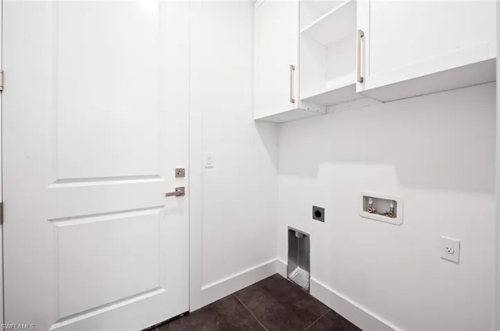 Washroom featuring cabinet space, hookup for an electric dryer, and washer hookup