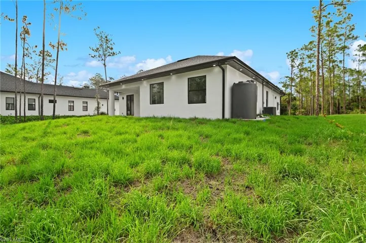 Rear view of house featuring stucco siding