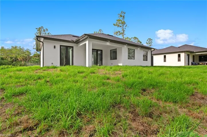 Rear view of house with stucco siding