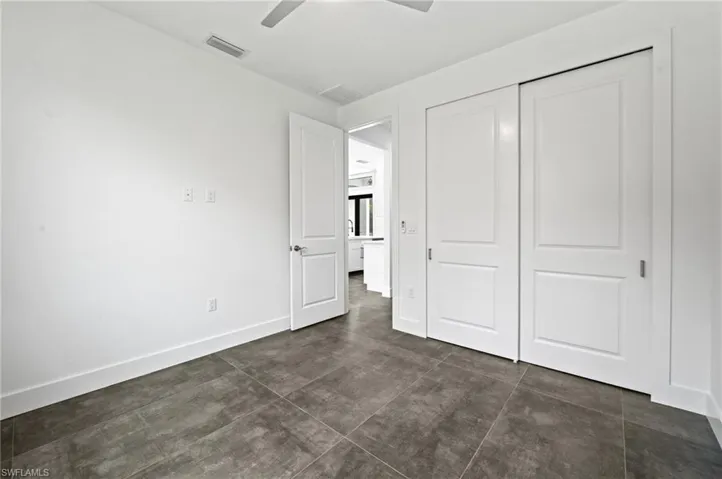 Unfurnished bedroom featuring a closet and ceiling fan