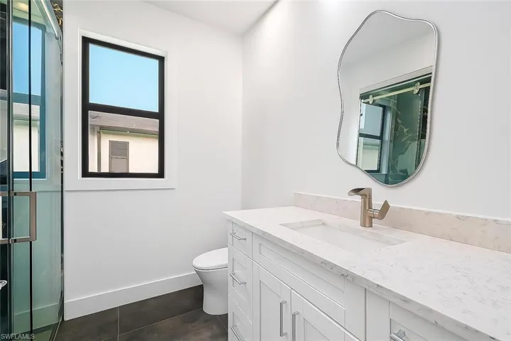 Full bath featuring vanity and tile patterned floors