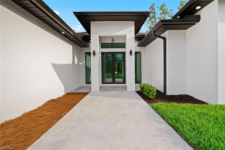 Doorway to property with french doors and stucco siding