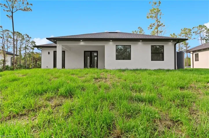 Rear view of house with stucco siding