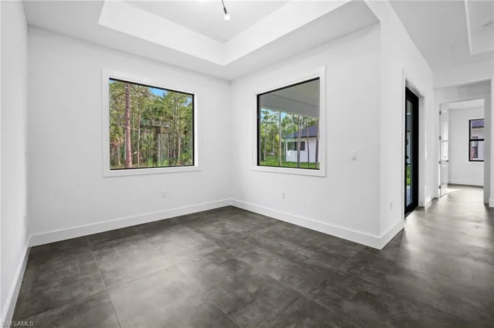 Spare room with plenty of natural light and concrete flooring